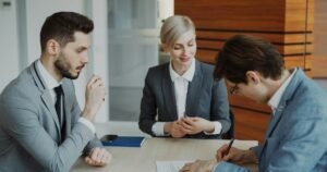 Business people signing a contract at a table